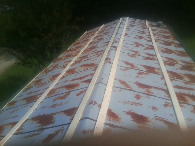 Rusted metal roof panels with new wood purlins before replacement — Storm Damage Roof Repair in Hookstown by Roofing Brothers