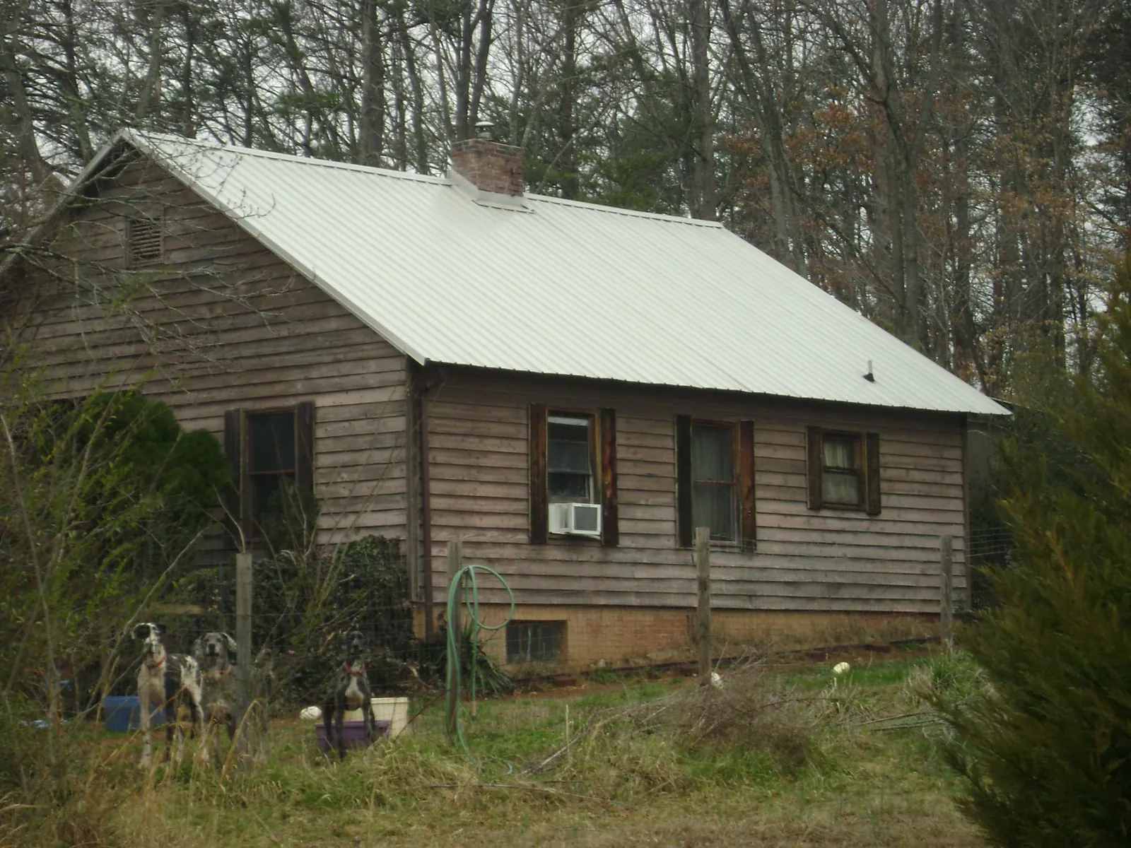 White metal roof on an old wood sided farmhouse, from a Metal Roof Installation job in Hookstown